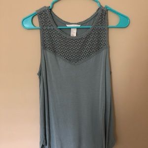 Light teal sleeveless top with lace-like detailing